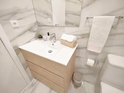 a white bathroom with a sink and a mirror at A Window to Porto – Premium Apartment Porto Downtown in Porto