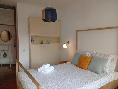 a bedroom with a bed with a stuffed animal on it at Travel & Live Bragas in Porto