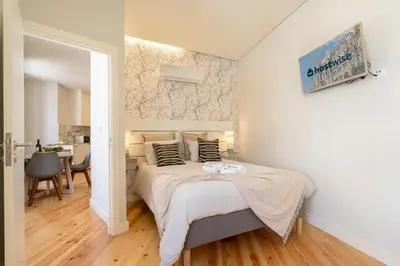 a bedroom with a bed with two towels on it at Host Wise - Enchanting Design Flat - Premium Location in Porto