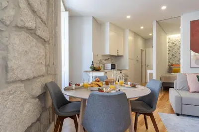 a kitchen and living room with a table and chairs at Host Wise - Enchanting Design Flat - Premium Location in Porto