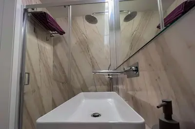 a bathroom with a white sink and a shower at Spacious Studio w/ Balcony & AC by LovelyStay in Porto