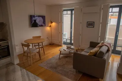 a living room with a couch and a table at Spacious Studio w/ Balcony & AC by LovelyStay in Porto