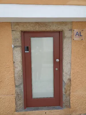 a red door on a building with a sign on it at CHARM APARTMENTS PORTO - Centro Batalha 1 in Porto