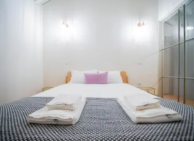 a bedroom with a bed with two towels on it at OportoCityView - Trindade Almada in Porto