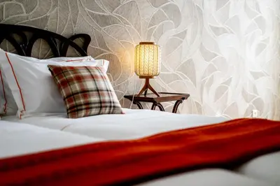 a bed with a pillow and a lamp on a table at Mouzinho 129 - Sobreiro in Porto