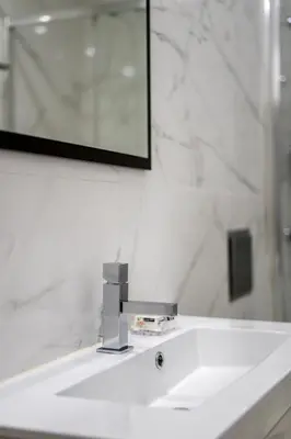 a bathroom sink with a mirror and a white sink at Mouzinho 129 - Sobreiro in Porto