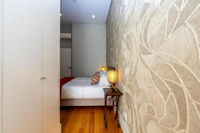 a bedroom with a bed and a wall at Mouzinho 129 - Sobreiro in Porto