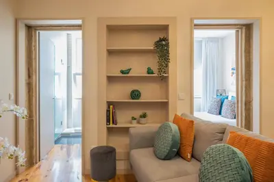 a living room with a couch and a mirror at PortoTile By RDC in Porto