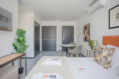 a living room with a bed and a table at Liiiving in Porto - City Design Studios in Porto