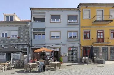 a group of buildings with tables and umbrellas at FLH Gaia Wine Cellars Flat in Vila Nova de Gaia