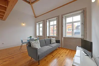 a living room with a couch and a table at FLH Porto Santa Catarina Duplex in Porto