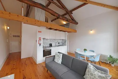 a living room with a couch and a table at FLH Porto Santa Catarina Duplex in Porto