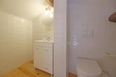 a white bathroom with a toilet and a sink at FLH Porto Santa Catarina Duplex in Porto