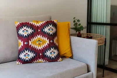 a couch with a colorful pillow on top of it at Urban Luxury Apartment, Downtown Porto near Metro in Porto