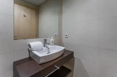 a white bathroom with a sink and a mirror at GuestReady - Artsy Apartment in Porto