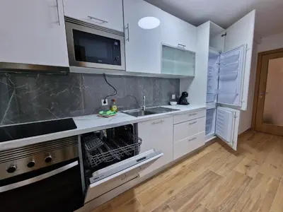 a kitchen with white cabinets and a sink and a dishwasher at Pretty flat with terrace, air cond, free parking, by Porto with Love LDA in Porto