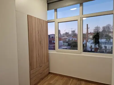 an empty room with two windows and a door at Pretty flat with terrace, air cond, free parking, by Porto with Love LDA in Porto