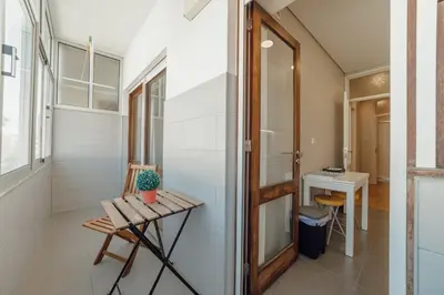 a small room with a table and a desk at Downtown Design Apartment With Balcony by Vacationy in Porto