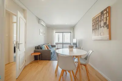 a living room with a table and a couch at Downtown Design Apartment With Balcony by Vacationy in Porto