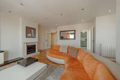 a living room with a couch and a fireplace at Downtown Grand Tower View by Vacationy in Porto