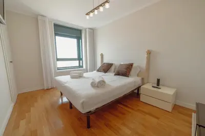 a bedroom with a bed with two towels on it at Downtown Grand Tower View by Vacationy in Porto