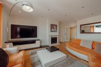 a living room with a couch and a flat screen tv at Downtown Grand Tower View by Vacationy in Porto