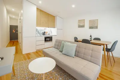 a living room with a couch and a table at Courtyard Oporto Design Apartments by Vacationy in Porto