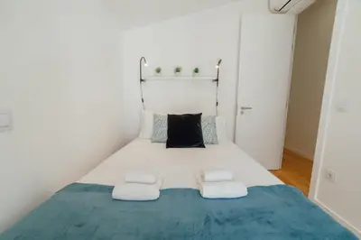 a small bedroom with a bed with two pillows at Courtyard Oporto Design Apartments by Vacationy in Porto