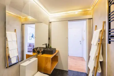 a bedroom with a bed and white walls at Casa da Música 5th High in Porto