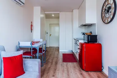 a room with a table and a kitchen with a window at Emotions Porto Flat in Porto
