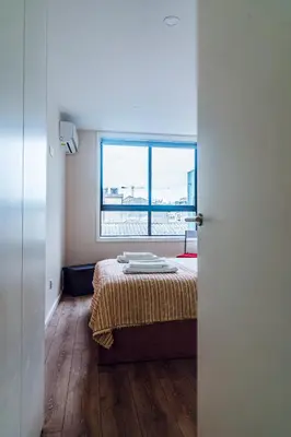 a bedroom with a bed and a large window at Emotions Porto Flat in Porto