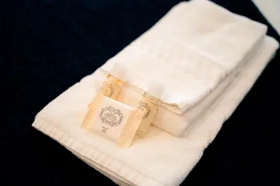a pile of white towels sitting on a table at Emotions Porto Flat in Porto