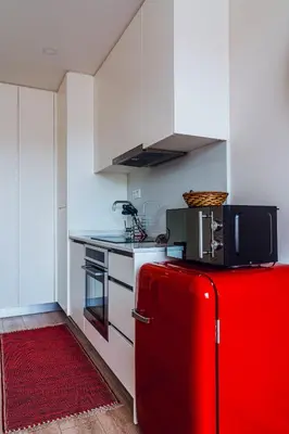 a kitchen and a living room with a red refrigerator at Emotions Porto Flat in Porto
