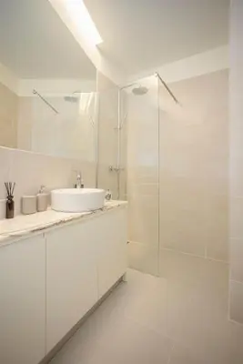 a white bathroom with a sink and a shower at Liiiving in Porto - Aliados Stone Apartment in Porto