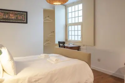 a bedroom with a bed with towels on it at Fancy Ribeira Porto in Porto