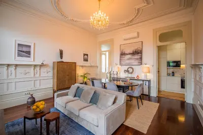 a living room with a couch and a table at Paraíso Garden Suite--- Spacious & Downtown in Porto