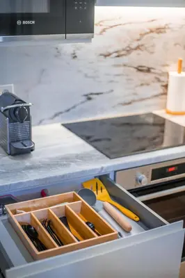 a drawer in a kitchen with a tray of knives at Paraíso Garden Suite--- Spacious & Downtown in Porto