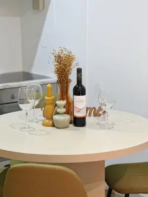 a table with two wine glasses and a bottle of wine at Downtown A whole house duplex designed for remote work and near metro lapa in Porto