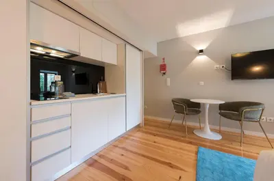 a bedroom with a large bed and a desk at Porto Central Loft II in Porto