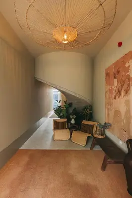a hallway with chairs and a large chandelier at Village By BOA in Porto