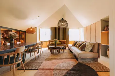 a living room with a couch and a bar at Village By BOA in Porto