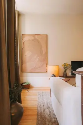a living room with a couch and a painting on the wall at Village By BOA in Porto