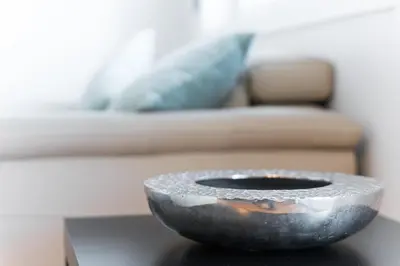 a bowl sitting on a table in front of a couch at GuestReady - Urban Retreat in Gaia in Vila Nova de Gaia