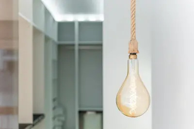 a glass light bulb hanging from a wall at GuestReady - Urban Retreat in Gaia in Vila Nova de Gaia