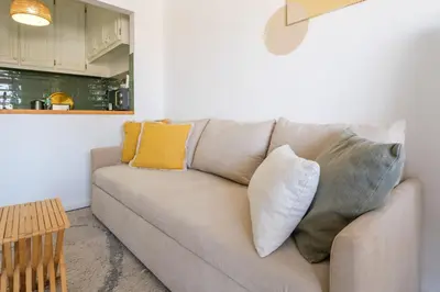 a living room with a couch with pillows at Santa Catarina Panoramic Loft in Porto