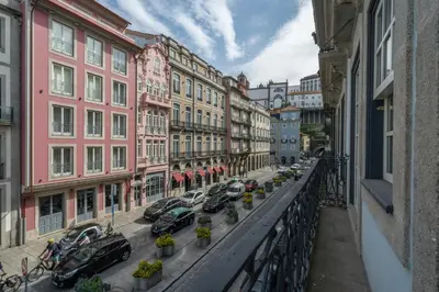 a city street with cars parked in front of a building at Infante Apartment by Amber Star Rent in Porto