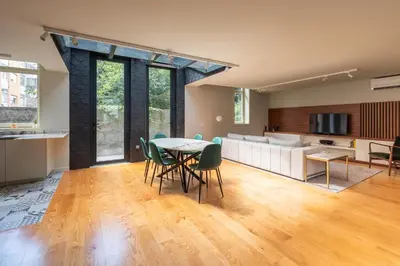 a kitchen and living room with a table and chairs at Oporto INNside House in Porto