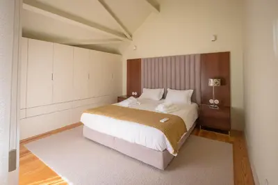 a bedroom with a large bed in a room at Oporto INNside House in Porto