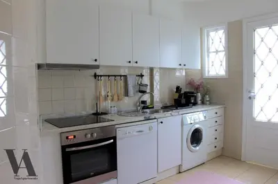 a white kitchen with a sink and a dishwasher at Voga Apartments Sta Catarina in Porto