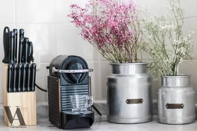 a kitchen counter with a blender and two vases with flowers at Voga Apartments Sta Catarina in Porto